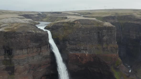 Birds Eye View of Haifoss Waterfall Flowing and Dropping Between Canyon in South Iceland