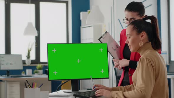 Colleagues Working with Green Screen on Display