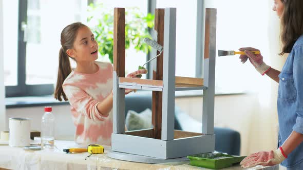 Mother and Daughter Painting Old Table at Home