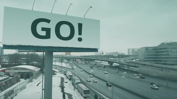 Billboard with GO Word at Urban Highway in Winter