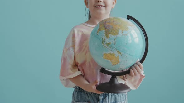 Portrait of 8-Year-Old Girl with World Globe alt