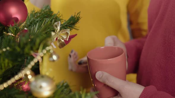 Man and Woman Holding Cups of Delicious Warm Drink in Hands, Christmas Spirit