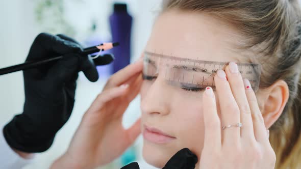 Cosmetologist Making Eyebrow Permanent Makeup