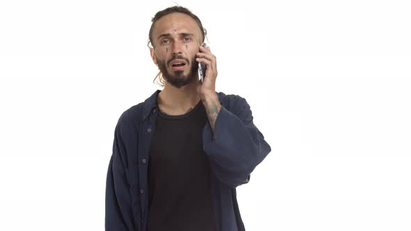 Attractive Hipster with Tattooed Body and Face Pick Up Phone and Receive Bad News Having