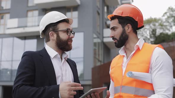 Construction Manager and Architect Man Are Discussing the Construction Plan of the Modern Business