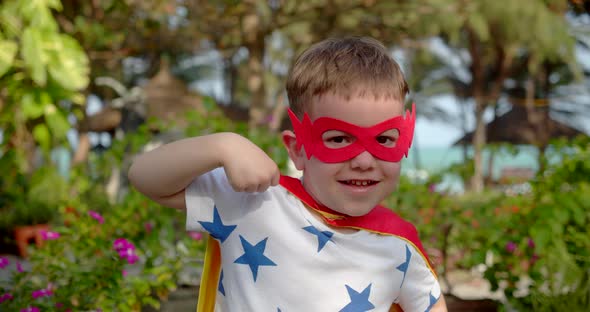 Close Up Portrait Cute Baby Boy Plays Superhero