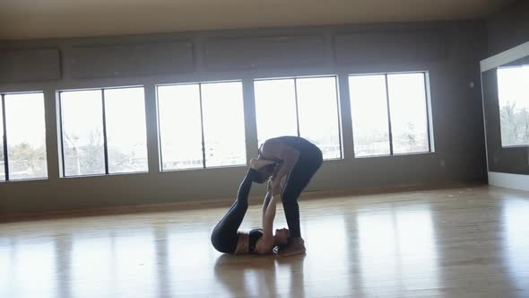 Partner Yoga performance done by two professional instructors