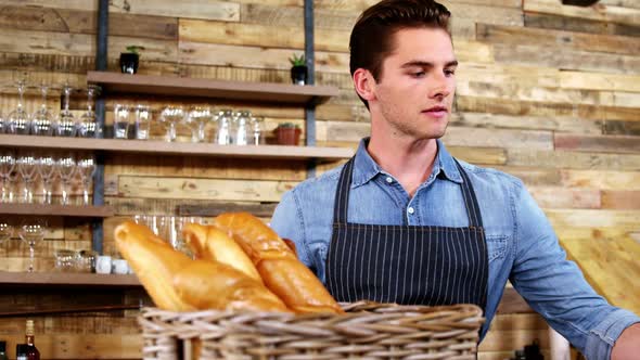 Male waiter working at counter