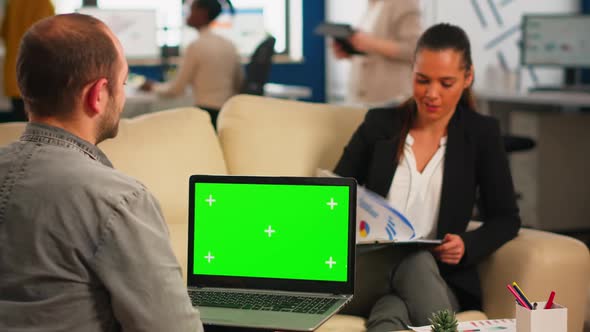 Over the Sholder of Manager Holding Laptop with Green Screen