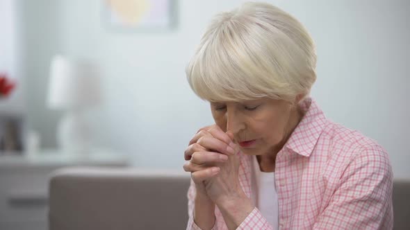 Elderly Woman Praying to God