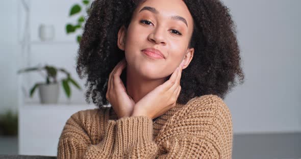 Portrait of a Female Face with Perfect Dark Skin and Natural Makeup African Woman Straightens Curly