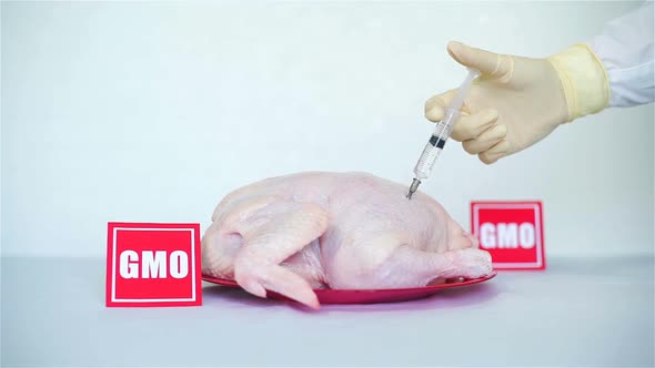 Hand Doing Injection Into a Raw Chicken