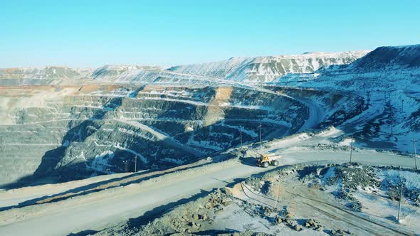 Snowy Mine Site with a Truck Transporting Ore