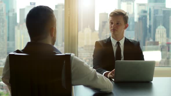 Business Meeting of Two Young Caucasian Businessman