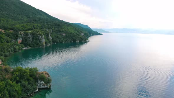 Aerial shot of Macedonia coast. Clif and beautiful water around Ohrid Lake in Southern Europe.