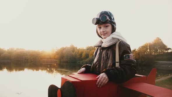 Atmospheric Portrait Shot of Cute Girl in Fun Retro Plane Pilot Costume Looking at Camera with Calm