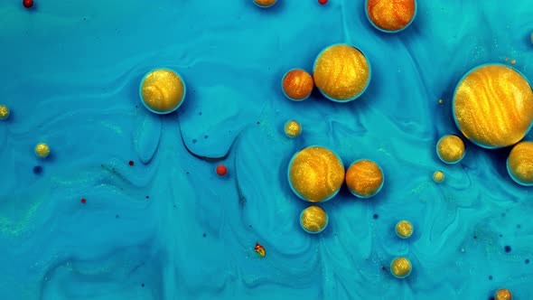 Gold Liquid Paint Bubbles. Abstract Color Background. Real Beautiful Substance Flows.