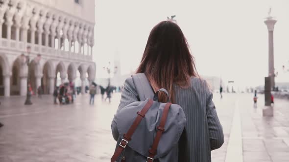 Beautiful Young Woman Walking on Amazing St Mark City Square in Venice, Italy, Touching Hair Back
