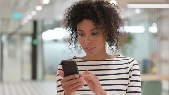 African Woman Having Loss on Smartphone