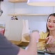Attractive asian female cafe worker  giving takeaway food bag to customer - VideoHive Item for Sale
