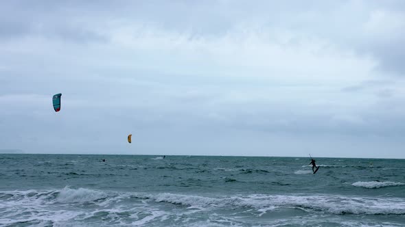 People Kite Boarding in the Sea with Huge Waves