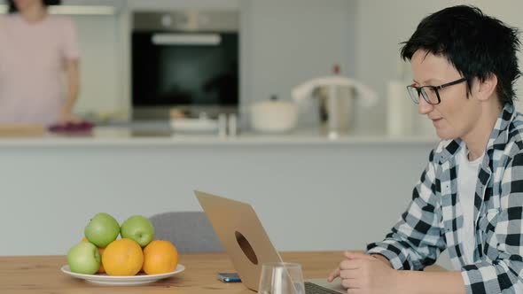 Young Lesbian Couple is Spending Good Day in Home Kitchen During Quarantine Rbbro