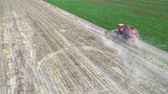 red harvester removes beets from the field top view