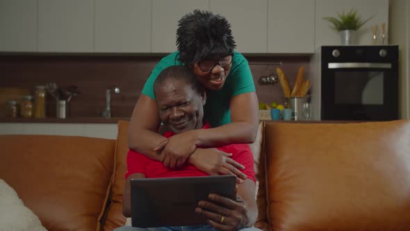 Loving Retired African Couple Hugging at Home