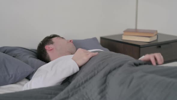 Man Laying in Bed Unable to Sleep