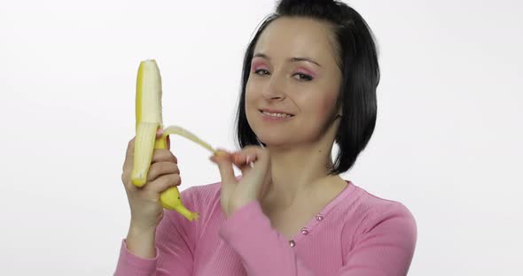 Young Woman Eating Banana and Says Yum. Girl Takes First Bite and Say Wanna Bite