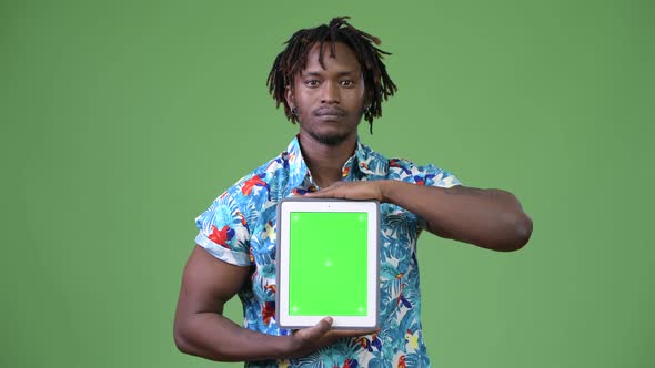 Young Handsome African Tourist Man Showing Digital Tablet