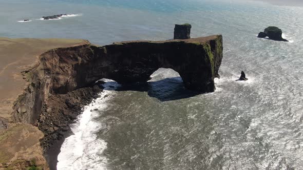 Lava arch at Dyrholaey peninsula next to Reynisfjara beach in Iceland