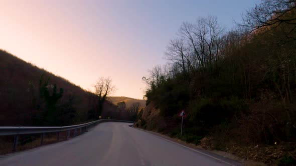 Car timelapse and sunset on the forest road