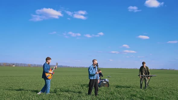 Group of young people playing instruments on field