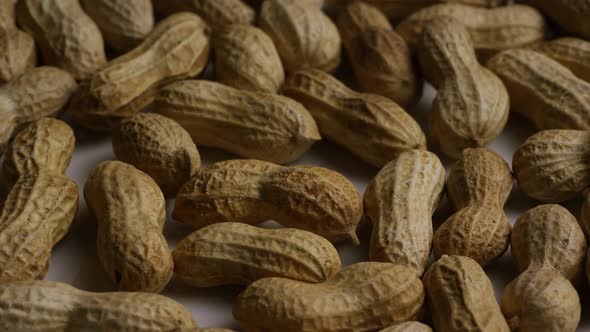 Cinematic, rotating shot of peanuts on a white surface - PEANUTS 010