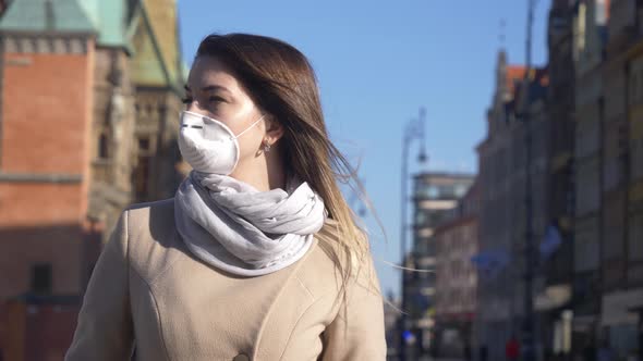 Blonde woman in care mask in old town of Wroclaw, Poland