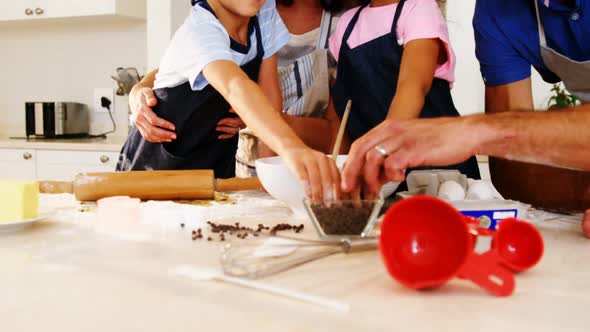 Happy family preparing cookies in kitchen