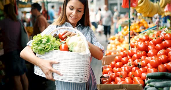 Picture of Woman at Marketplace Buying Vegetables