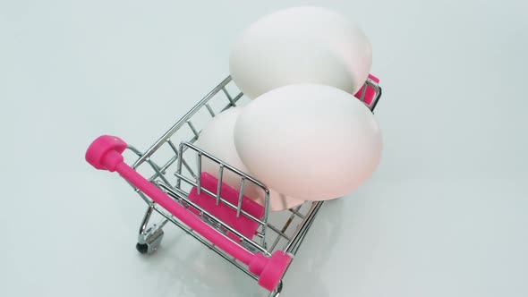 Top View Of White Chicken Eggs In A Grocery Trolley On Wheels From A Supermarket