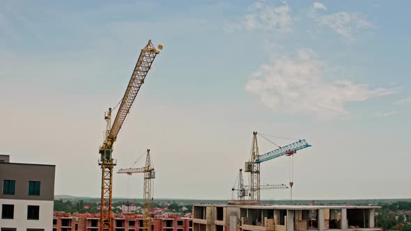 Aerial Drone View. High Cranes Works on Building Site with a House.