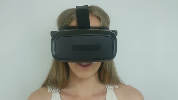 sexy woman in a virtual reality helmet uses the application