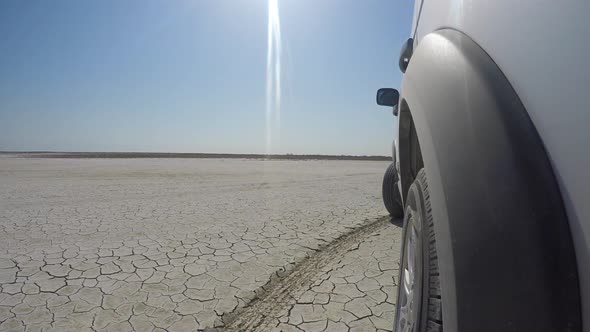 Car Going on Barren Desert Lands