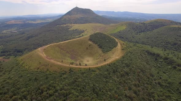 Aerial travel drone view of the Puy de Dome, lava dome volcano in France.