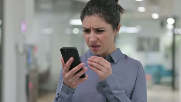 Portrait of Young Indian Woman Loss on Smartphone