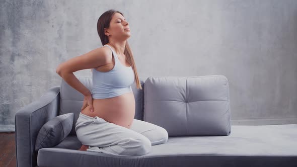 Young pregnant woman is resting at home and expecting a baby.