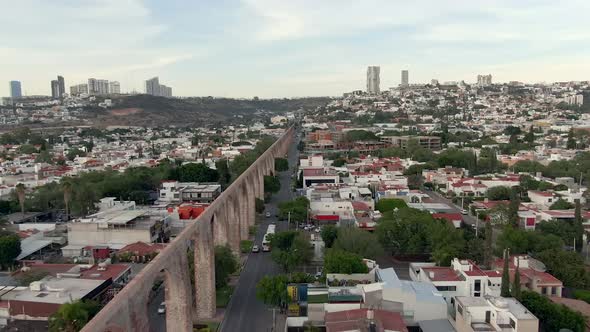 Acueducto de Queretaro In Middle Houses And Buildings In City Of Queretaro In Mexico. - aerial pullb