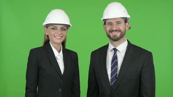 Two Construction Engineers Smiling While Looking at the Camera Against Chroma Key