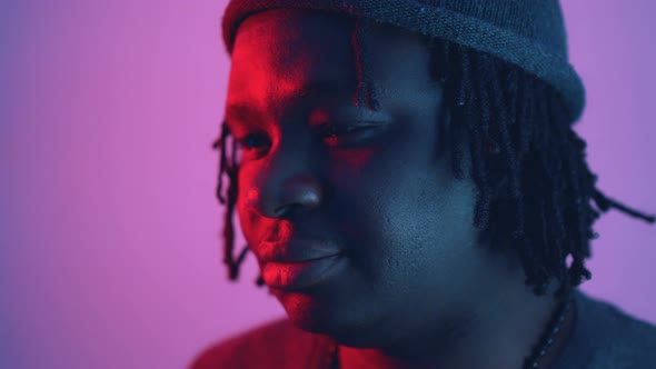 Pensive Young African American Black Man Lit with Red and Blue Light