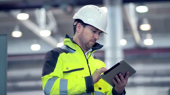 Engineer Is Using Tablet Pc In Factory