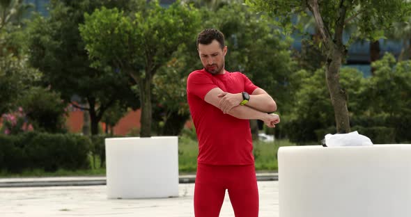 Man warm up and stretching outdoors for a workout.